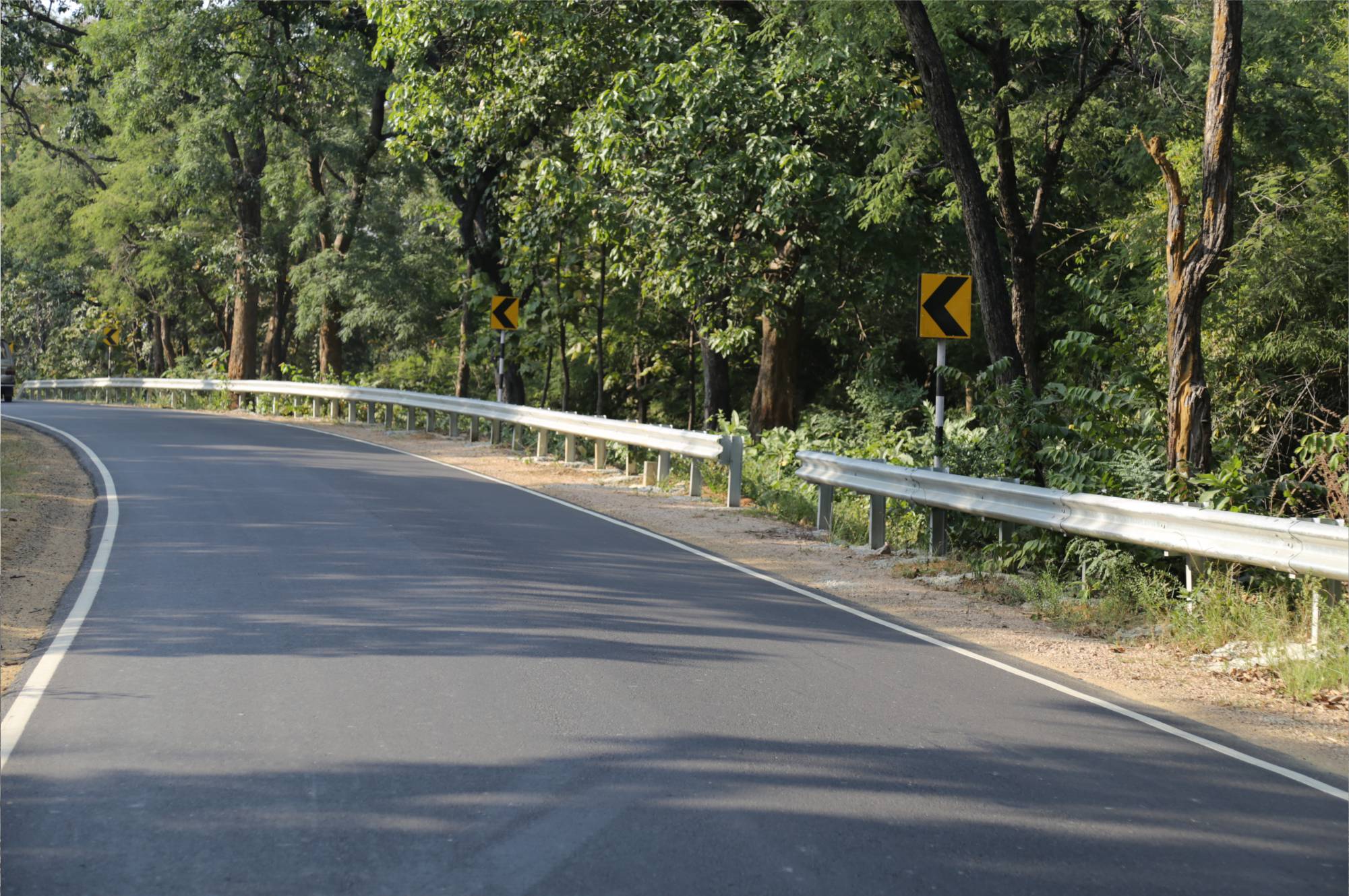 Completed NH353B highway through forest terrain